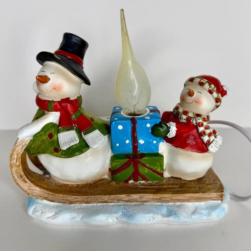 Sledding snowman and woman night light, winter light, snowman light
